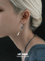 Single-hoop blue stone tassel earring shown from the side