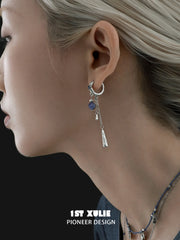 Blue stone tassel hoop earrings worn with the hair tucked back