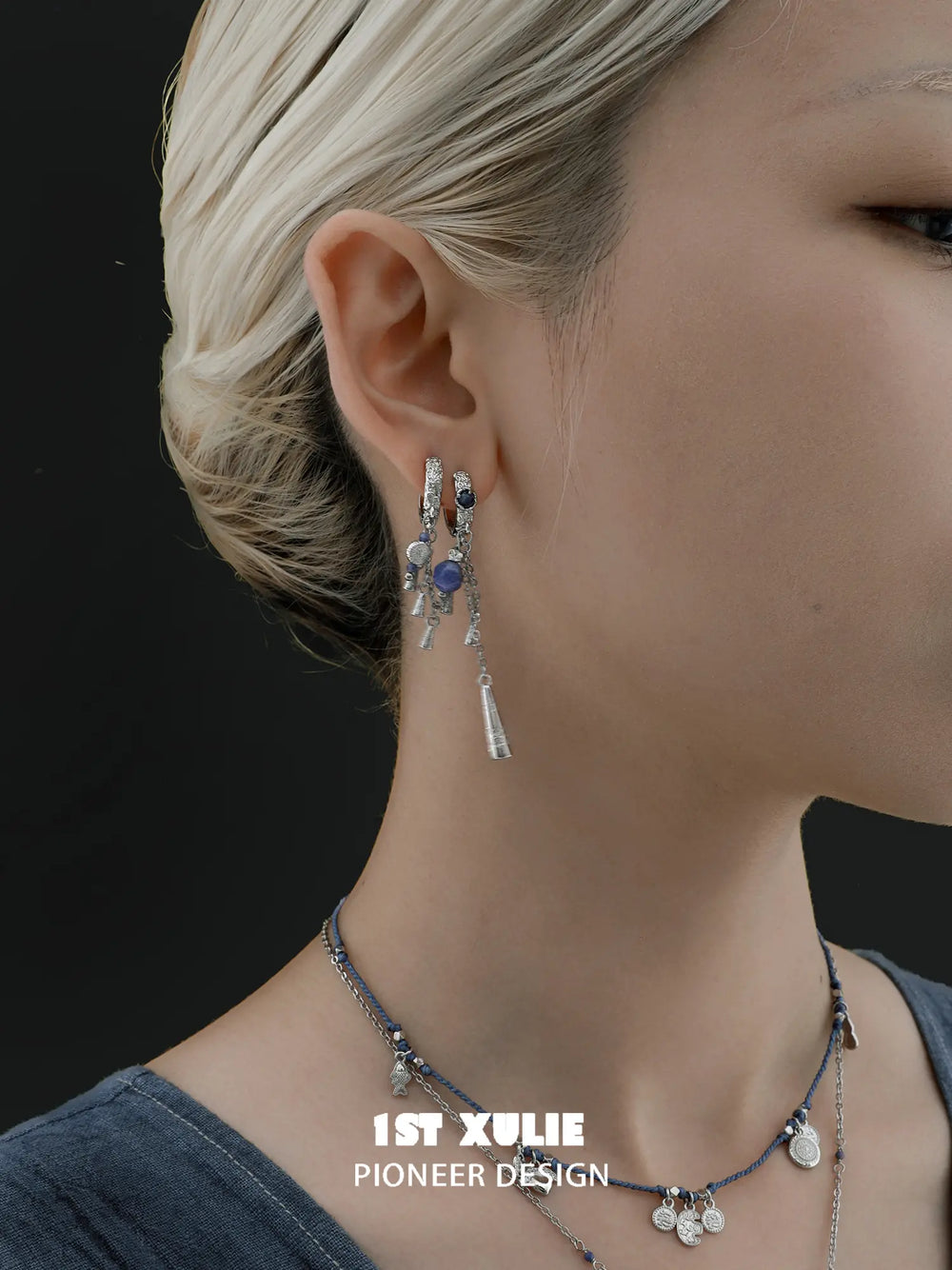 Blue stone tassel hoop earrings worn with the hair tucked back