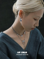 Blue stone tassel hoop earrings worn with the hair tucked back