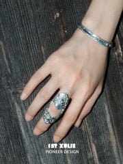 Blue woven open bangles worn with coordinating jewelry