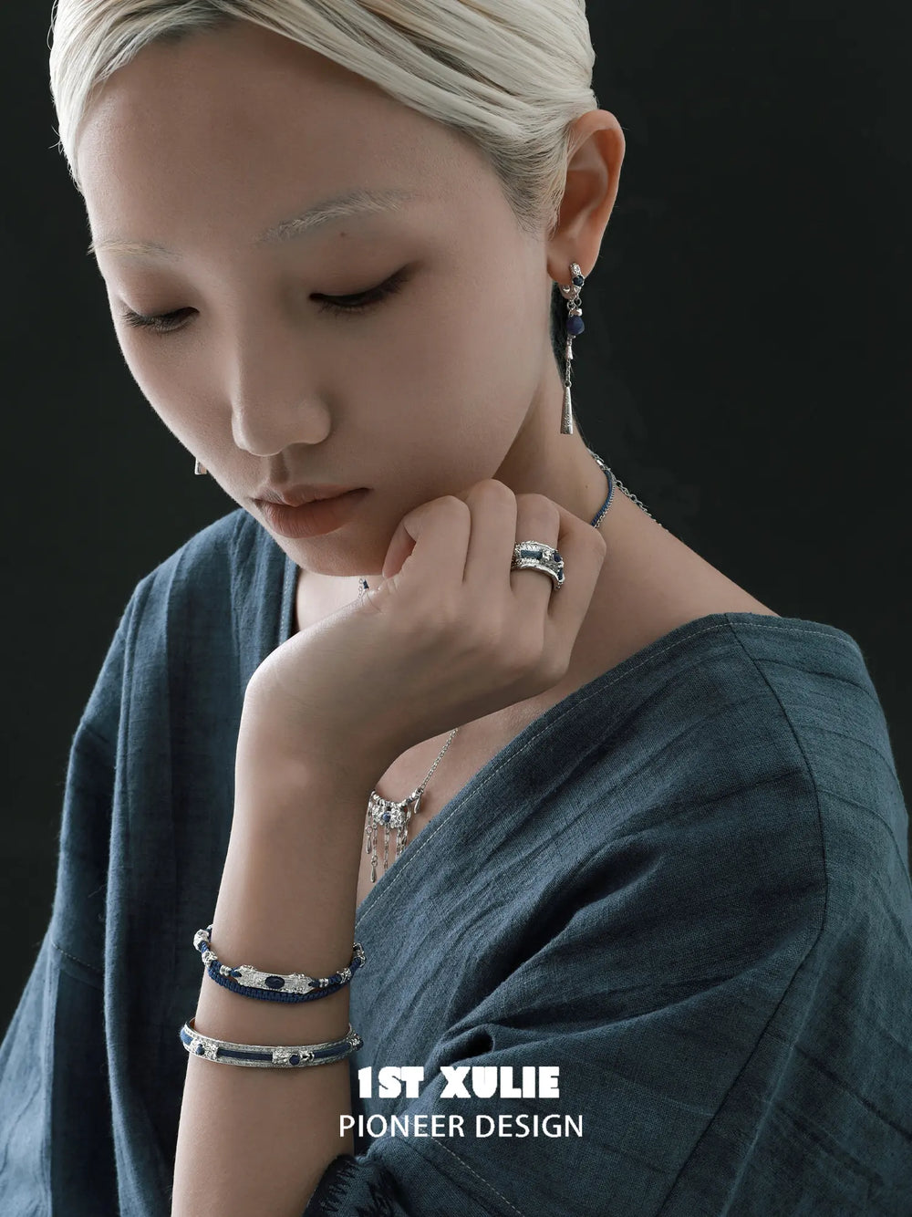 Blue woven open bangles worn with coordinating jewelry