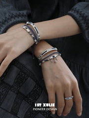 Blue woven open bangles worn with coordinating jewelry