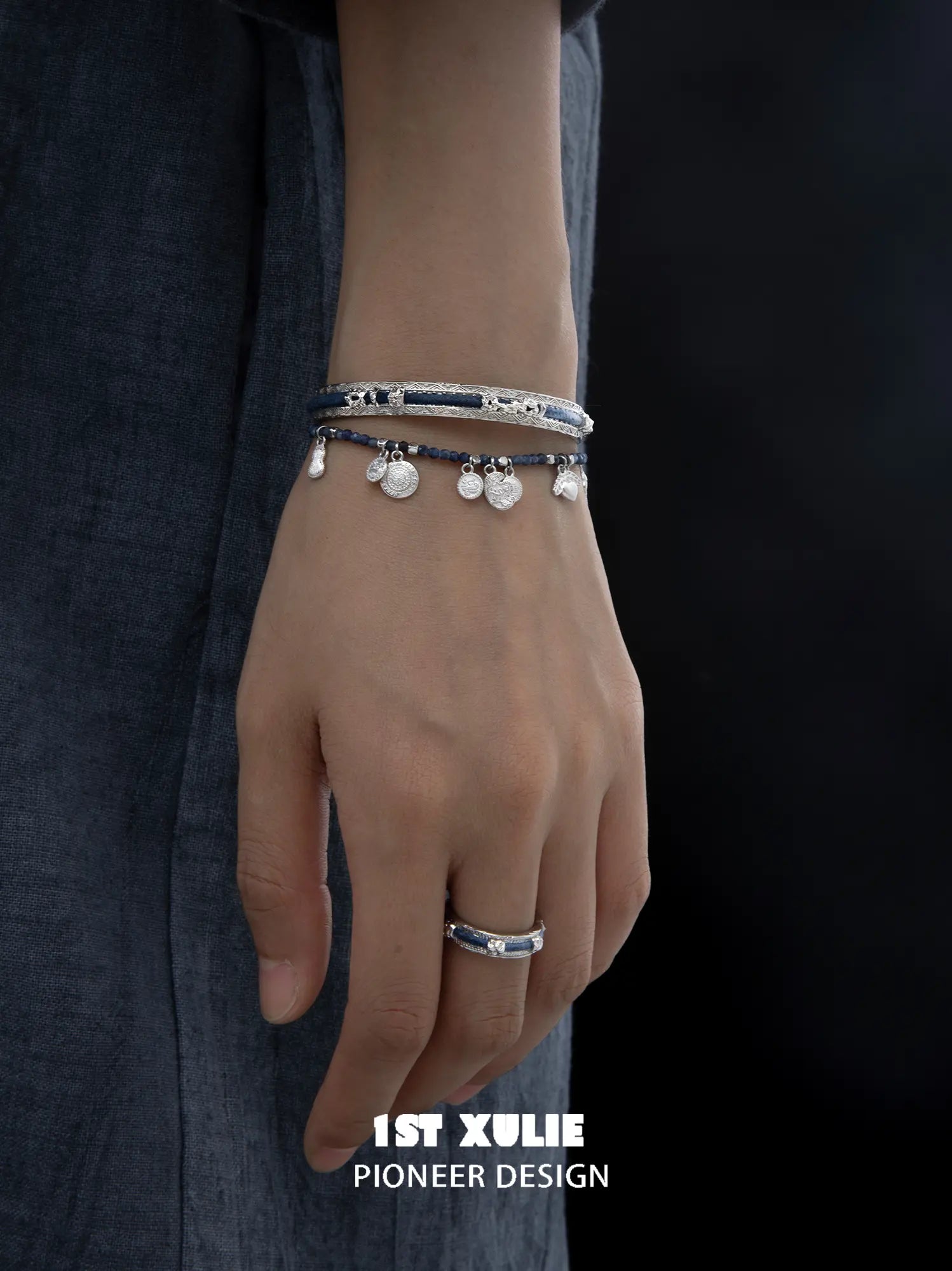 Blue woven open bangles worn with coordinating jewelry