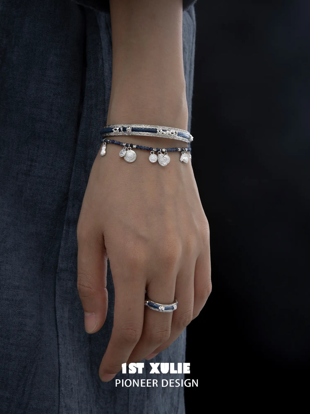 Blue woven open bangles worn with coordinating jewelry