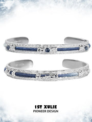 Blue woven open bangles showing the ornamental details and overall silhouette