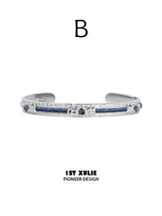 Style B blue woven open bangle with a central blue stone