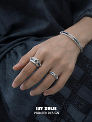 Narrow and wide blue woven rings worn with coordinating jewelry