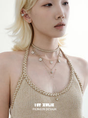 Side portrait showing the layered celestial necklaces