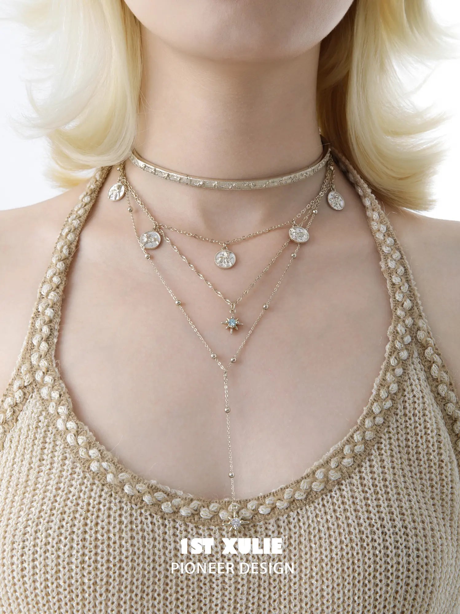Celestial choker and pendant necklaces worn together at the neckline