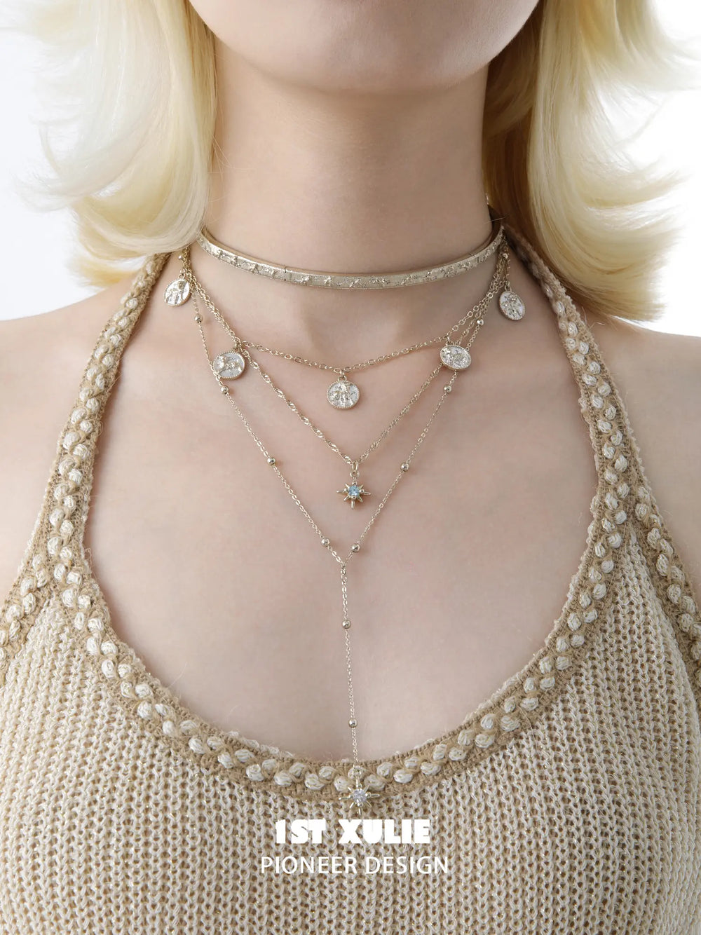 Celestial choker and pendant necklaces worn together at the neckline