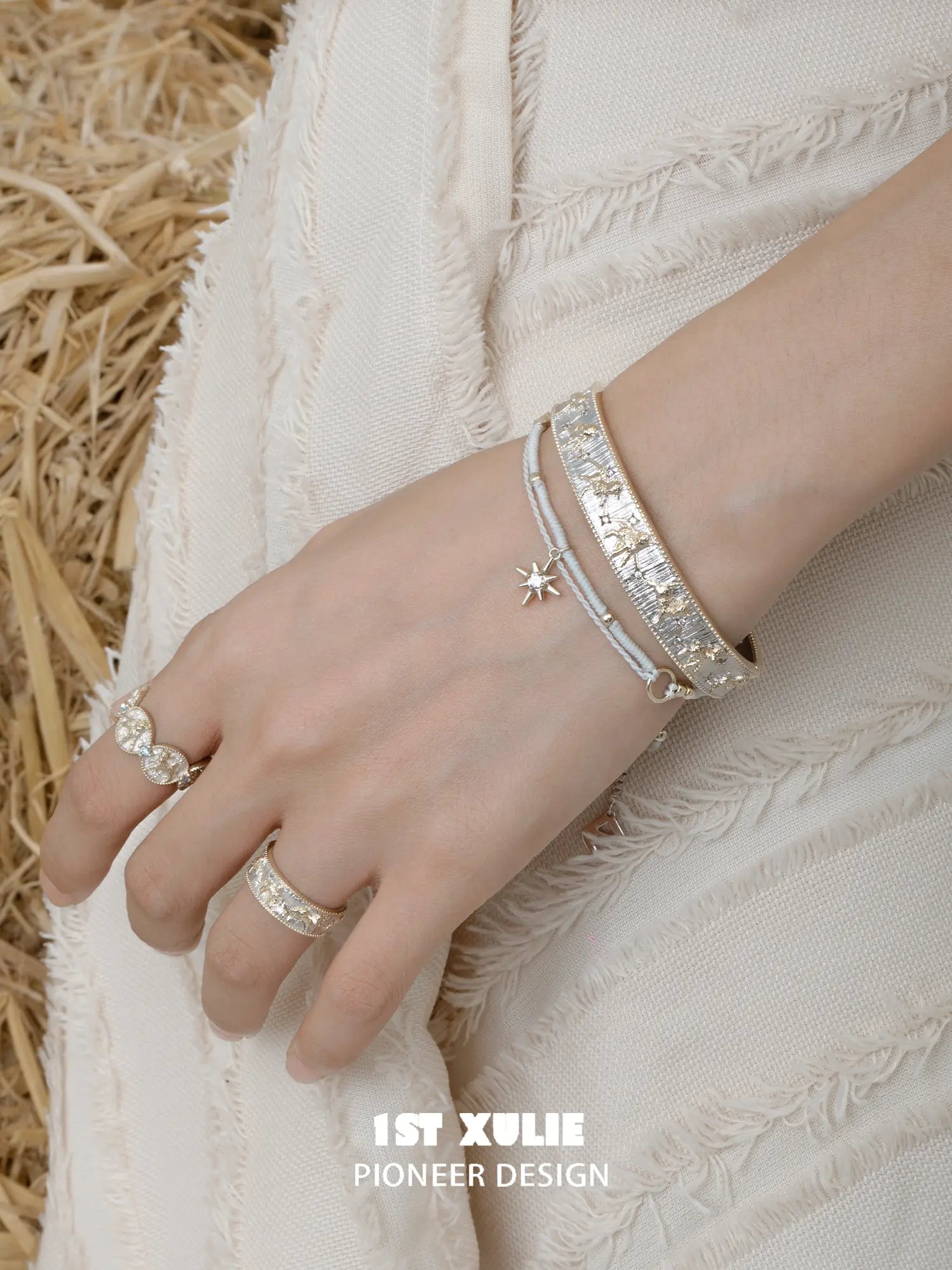 Celestial medallion and patterned band rings worn with coordinating jewelry