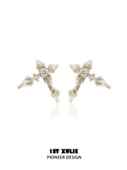 Gold-toned detachable fleur-de-lis earrings with elongated decorative sections