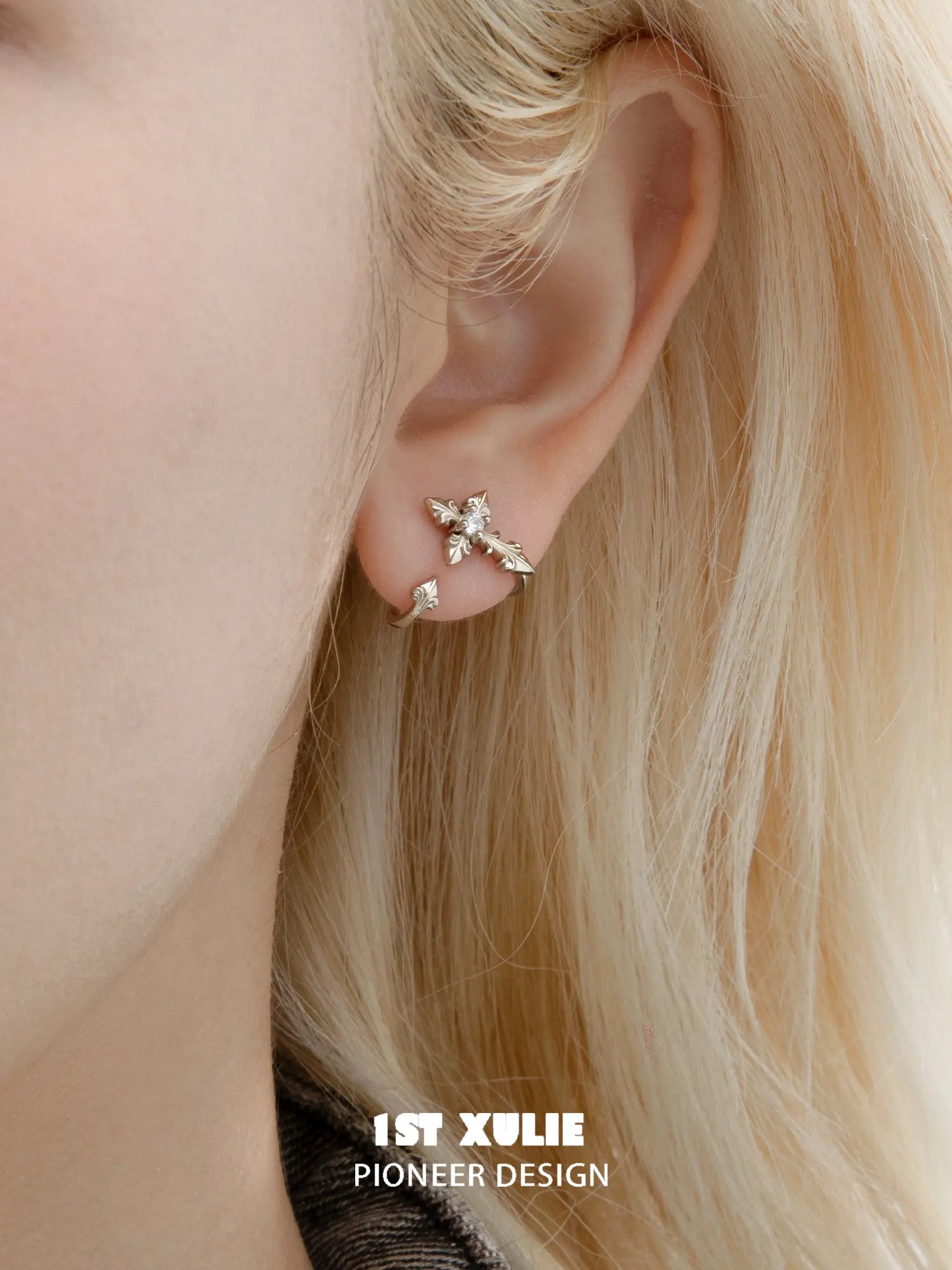 Small fleur-de-lis stud worn without the long detachable ornament