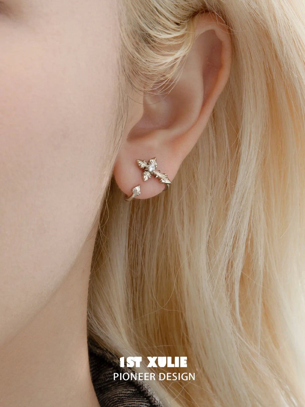 Small fleur-de-lis stud worn without the long detachable ornament