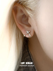 Close-up of the fleur-de-lis stud worn on the ear