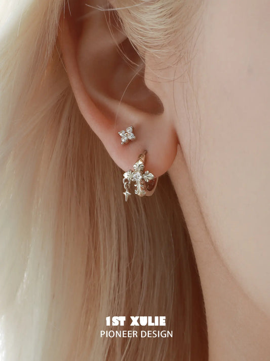 Fleur-de-lis hoop and stud earrings worn together on the ear