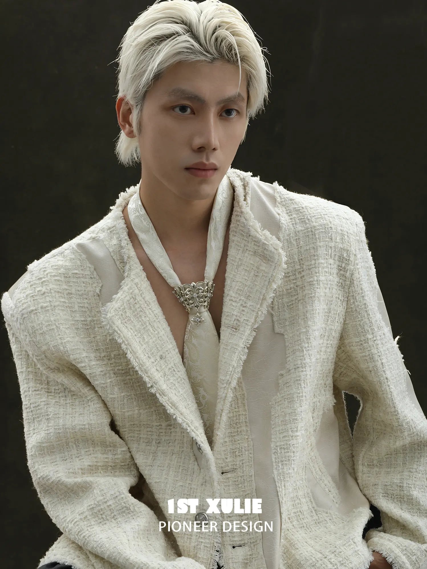 Fleur-de-lis tie brooch and coordinating neckties styled with a shirt and tailored clothing