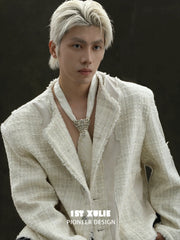 Fleur-de-lis tie brooch and coordinating neckties styled with a shirt and tailored clothing