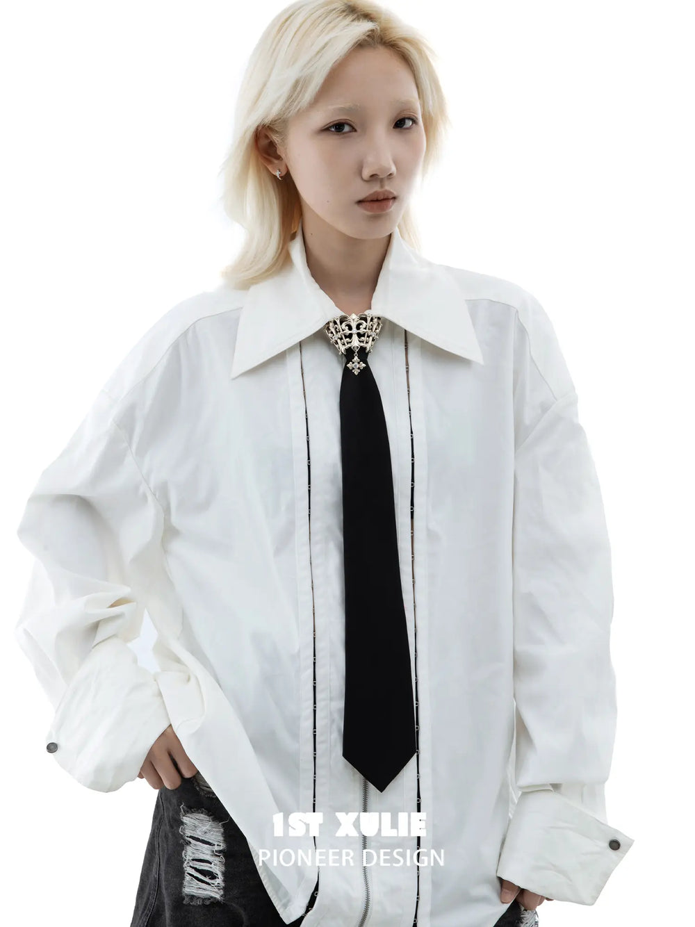 Fleur-de-lis tie brooch and coordinating neckties styled with a shirt and tailored clothing