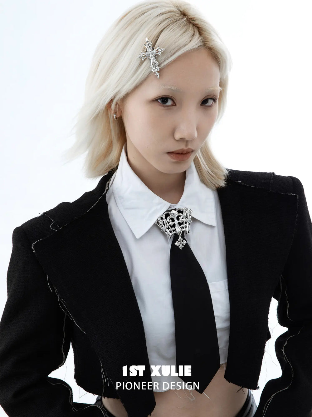 Fleur-de-lis tie brooch and coordinating neckties styled with a shirt and tailored clothing