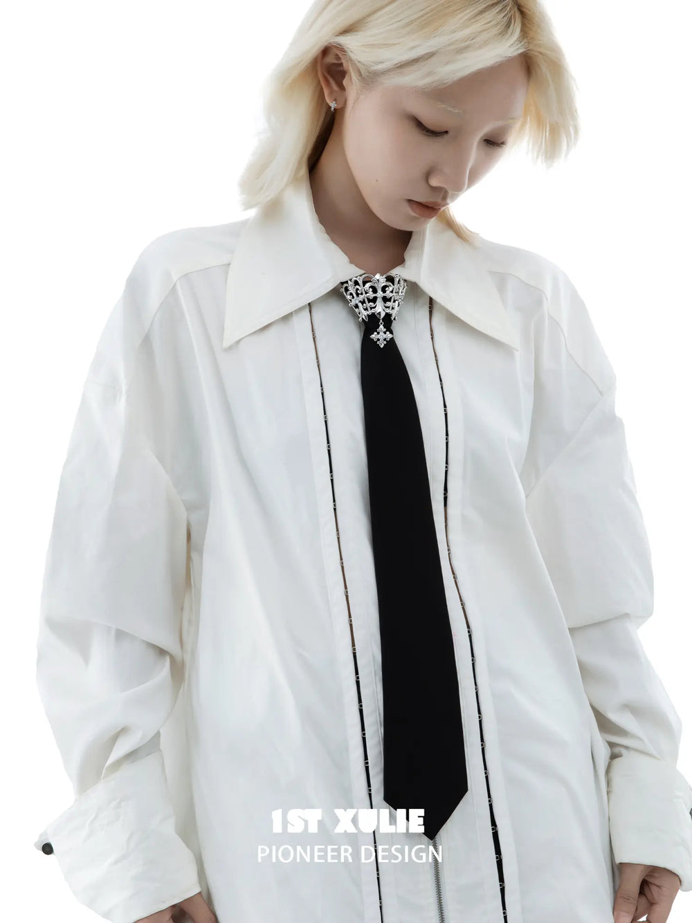 Fleur-de-lis tie brooch and coordinating neckties styled with a shirt and tailored clothing