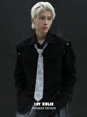 Silver-toned tie brooch styled with a patterned necktie and dark jacket