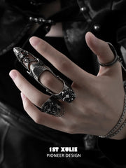 Gothic long armor and chain signet rings worn with coordinating jewelry
