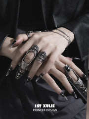 Gothic long armor and chain signet rings worn with coordinating jewelry