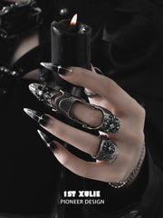 Gothic long armor and chain signet rings worn with coordinating jewelry