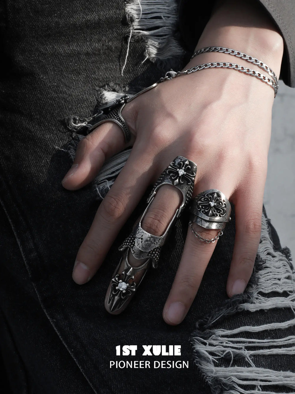 Gothic long armor and chain signet rings worn with coordinating jewelry