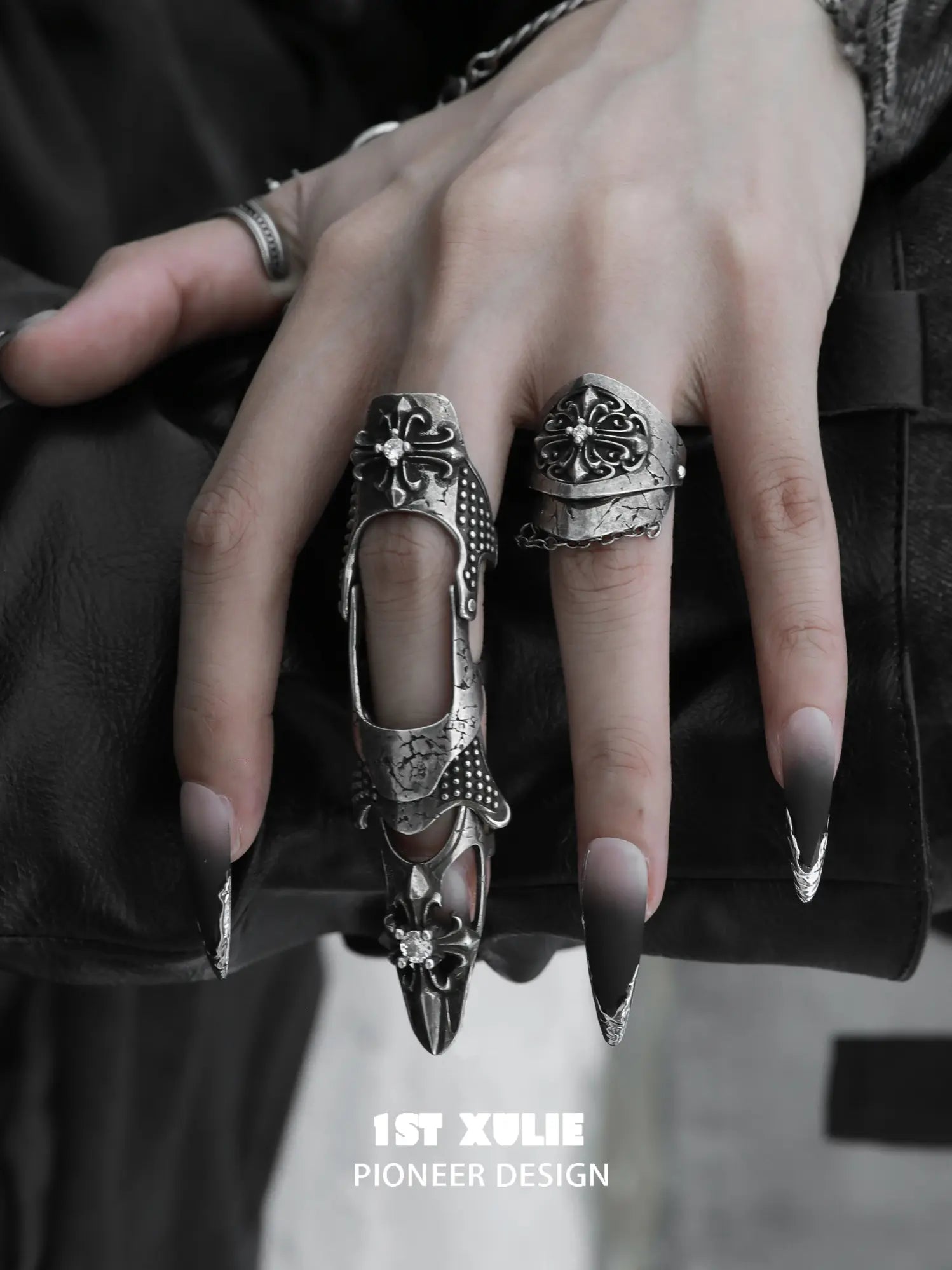 Gothic long armor and chain signet rings worn with coordinating jewelry