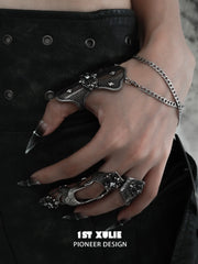 Gothic long armor and chain signet rings worn with coordinating jewelry