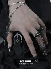 Gothic chain signet and long armor rings worn with coordinating jewelry