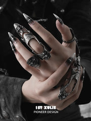 Gothic chain signet and long armor rings worn with coordinating jewelry