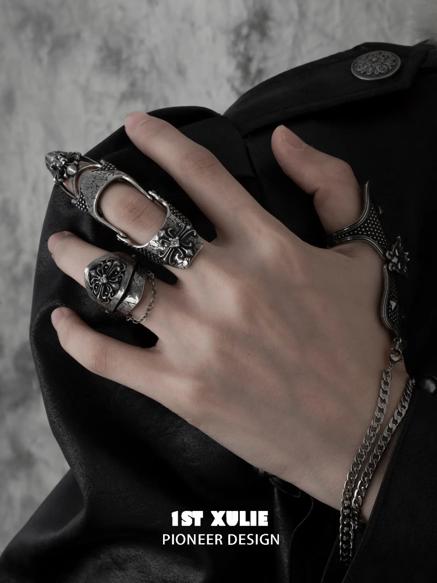 Gothic chain signet and long armor rings worn with coordinating jewelry