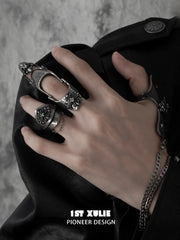 Gothic chain signet and long armor rings worn with coordinating jewelry