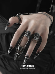 Gothic ring designs worn with dark styling and metallic nail tips