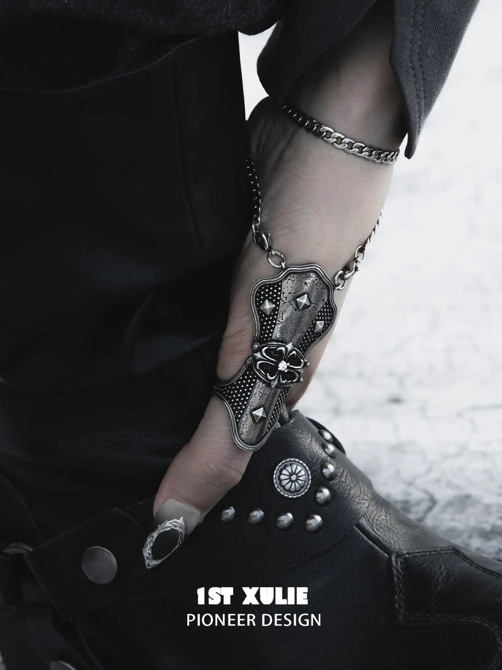 Gothic thumb armor ring and wrist chain worn with coordinating jewelry