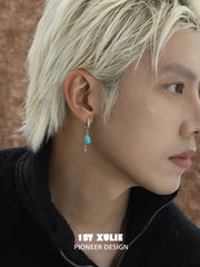 Natural turquoise drop hoop earrings worn on the ear