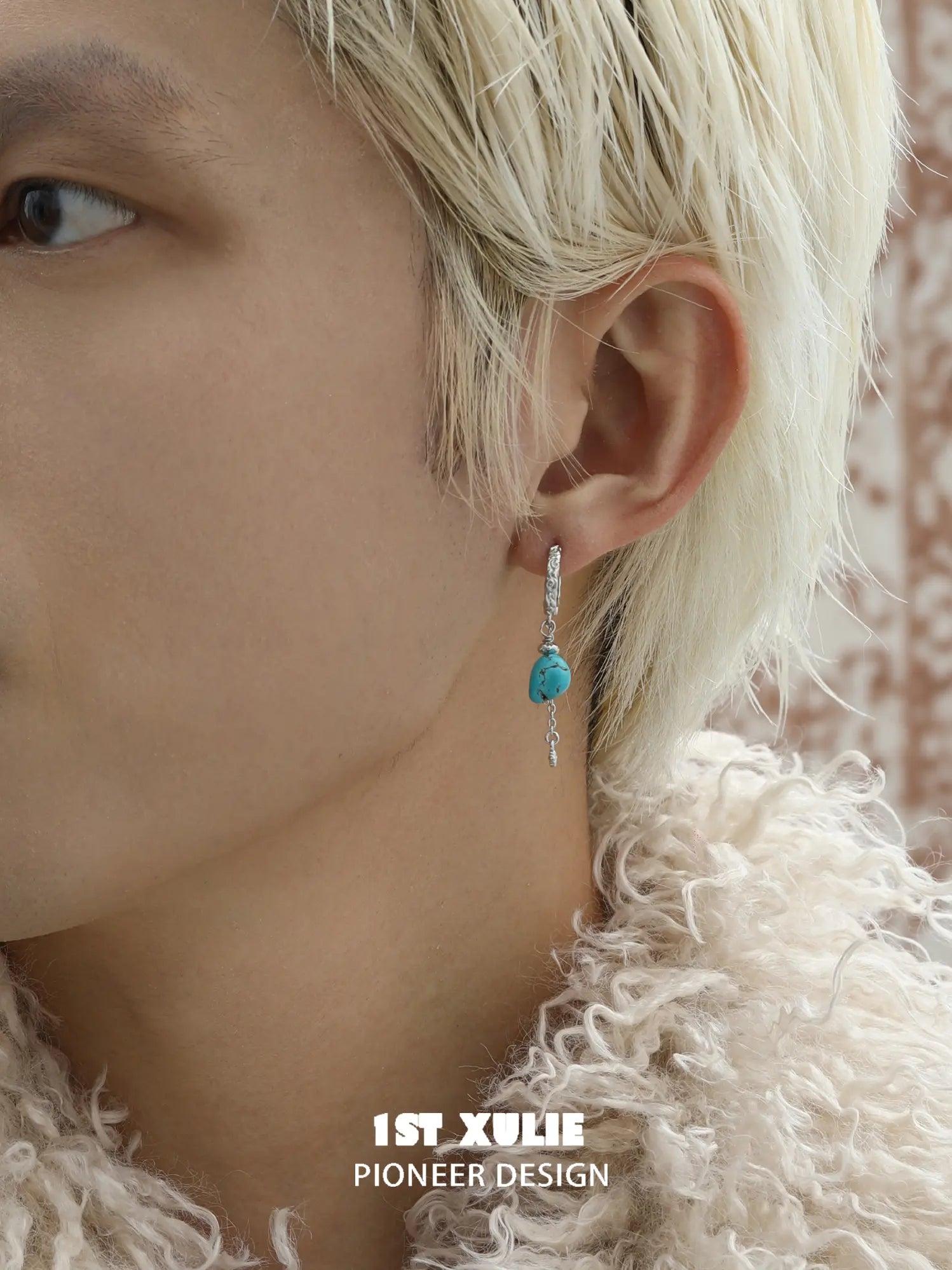 Natural turquoise drop hoop earrings worn on the ear