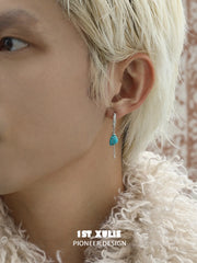 Natural turquoise drop hoop earrings worn on the ear