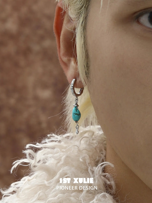 Natural turquoise drop hoop earrings worn on the ear