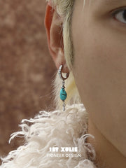 Natural turquoise drop hoop earrings worn on the ear