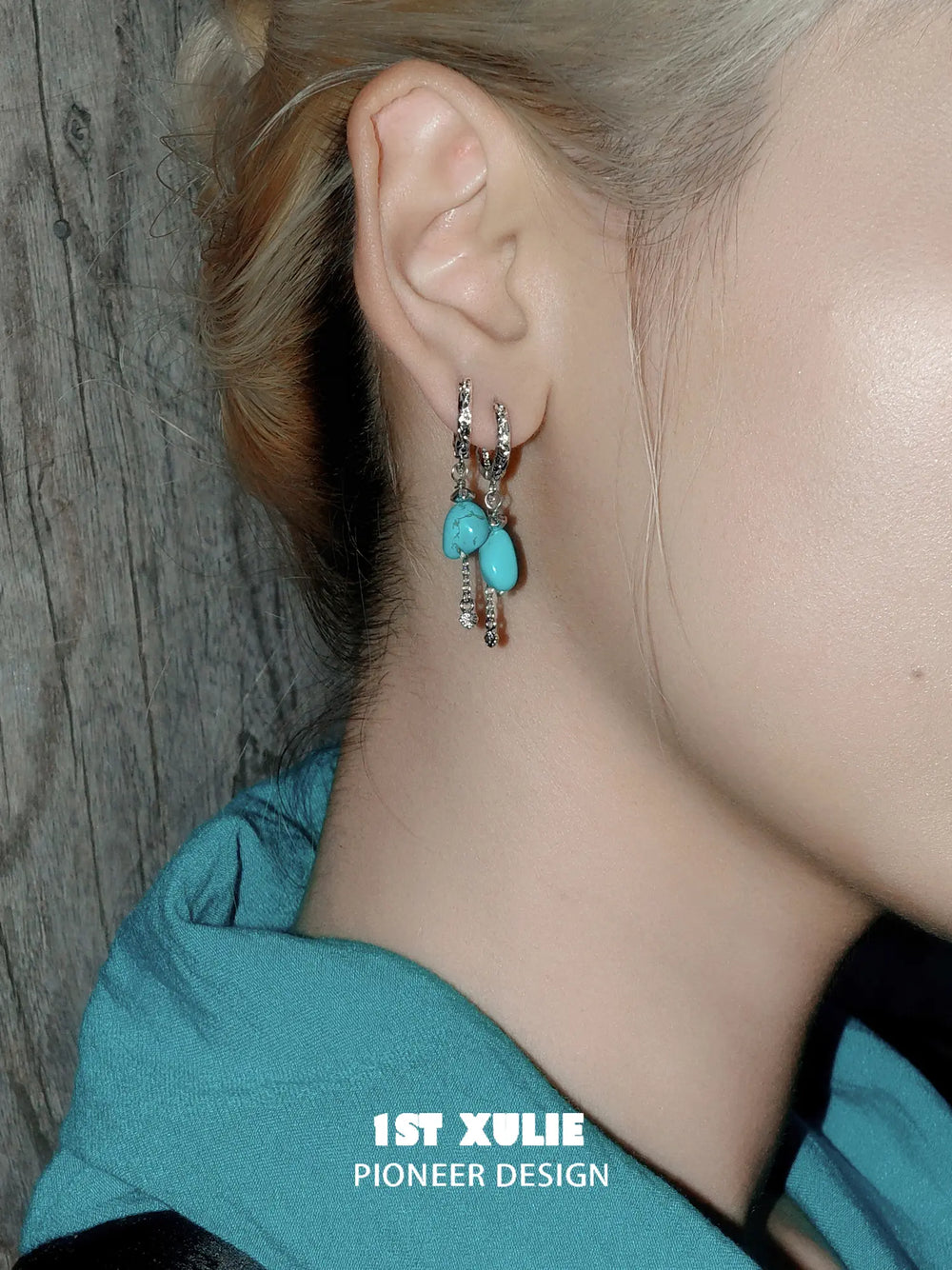 Irregular turquoise earrings shown with the hair tucked behind the ear