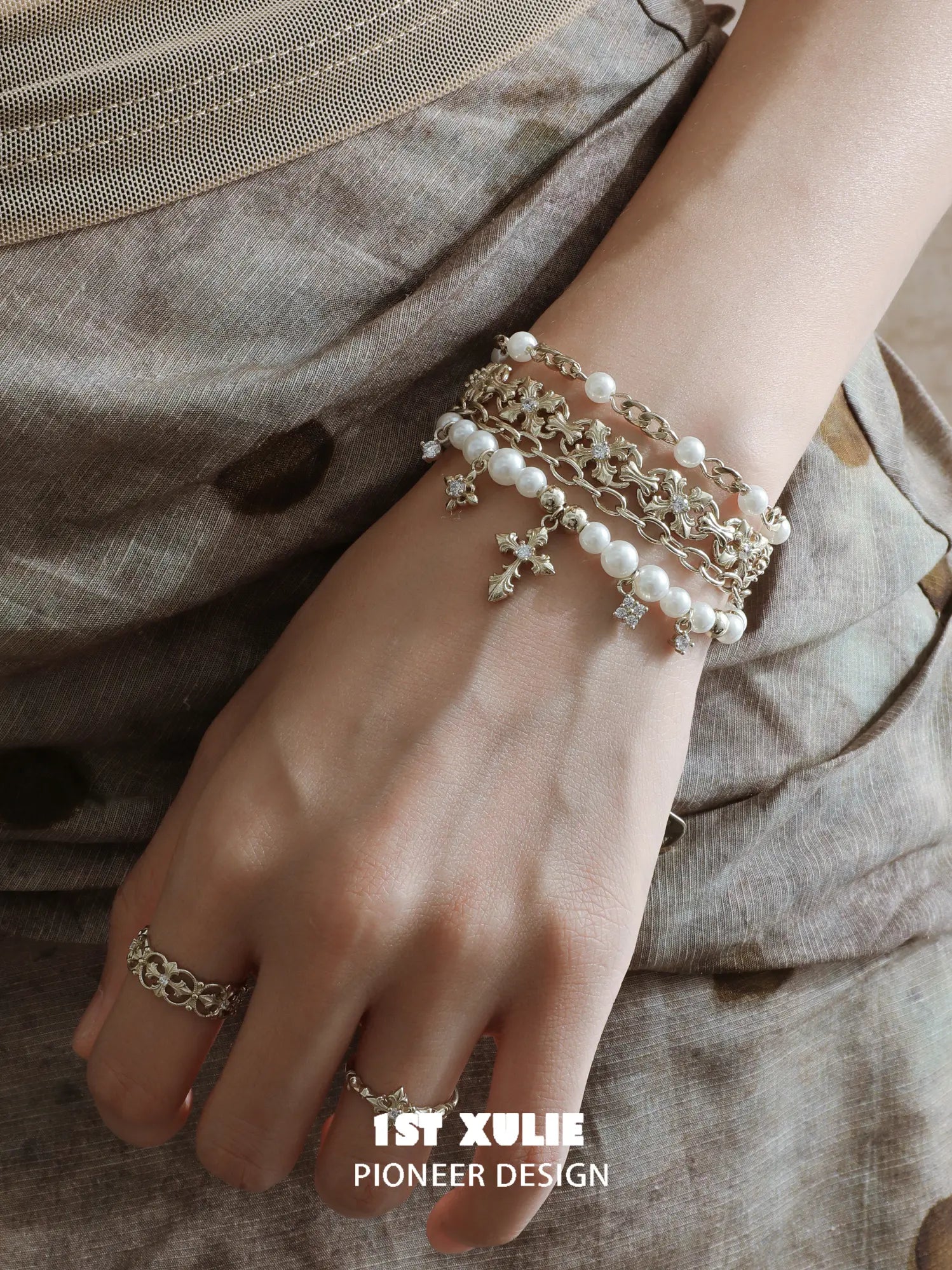 Pearl-bead fleur-de-lis bracelet worn on the wrist