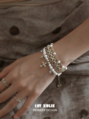 Side view of the layered pearl-bead bracelet on a wrist