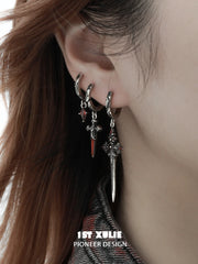 Three red-accented gothic hoop styles worn together on the ear