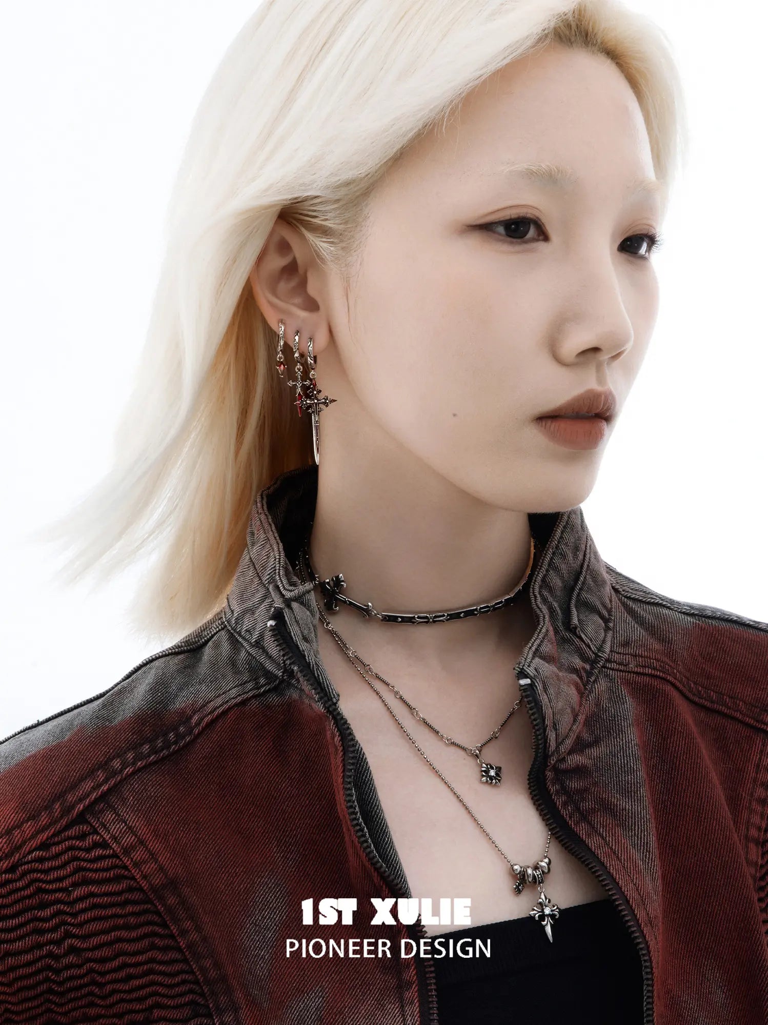 Red drop and dagger hoop earrings worn together on the ear