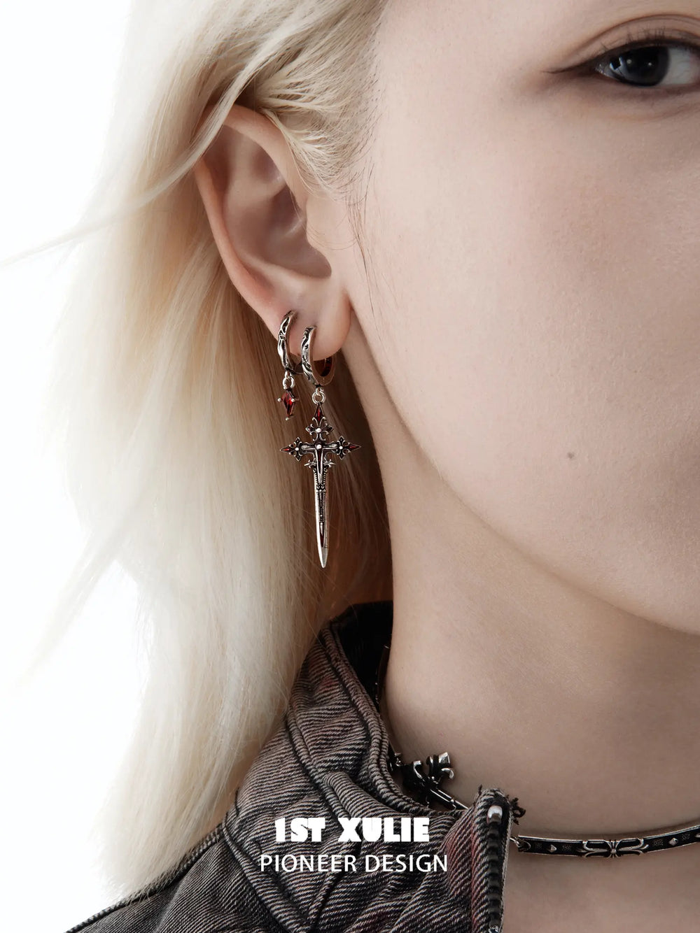 Red drop and dagger hoop earrings worn together on the ear